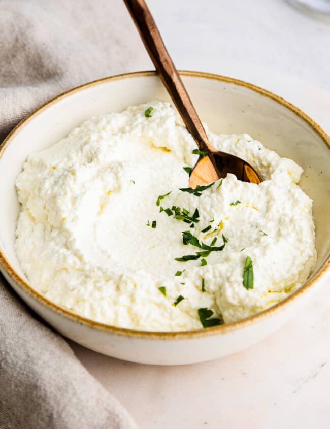 spoon in ricotta in bowl