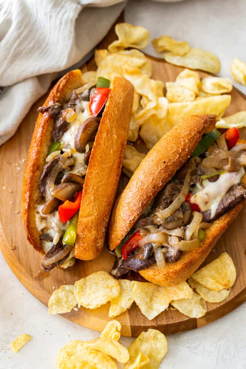 overhead two philly cheesesteaks on cutting board