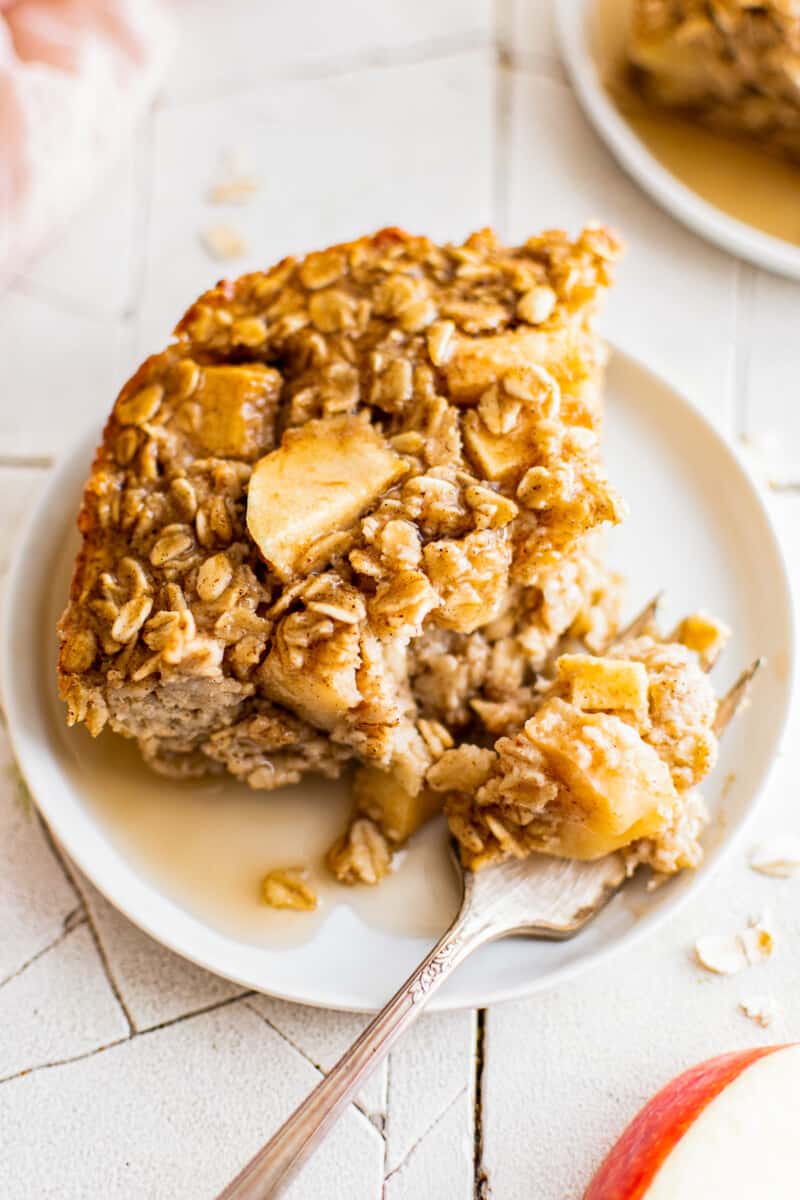 up close slice of baked apple oatmeal on white plate