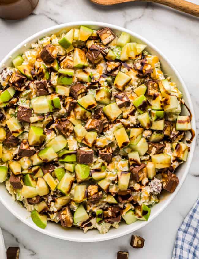 white bowl filled with snickers apple salad