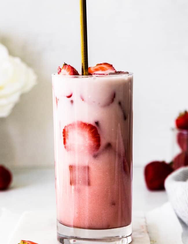 starbucks pink drink with fresh strawberries with gold straw