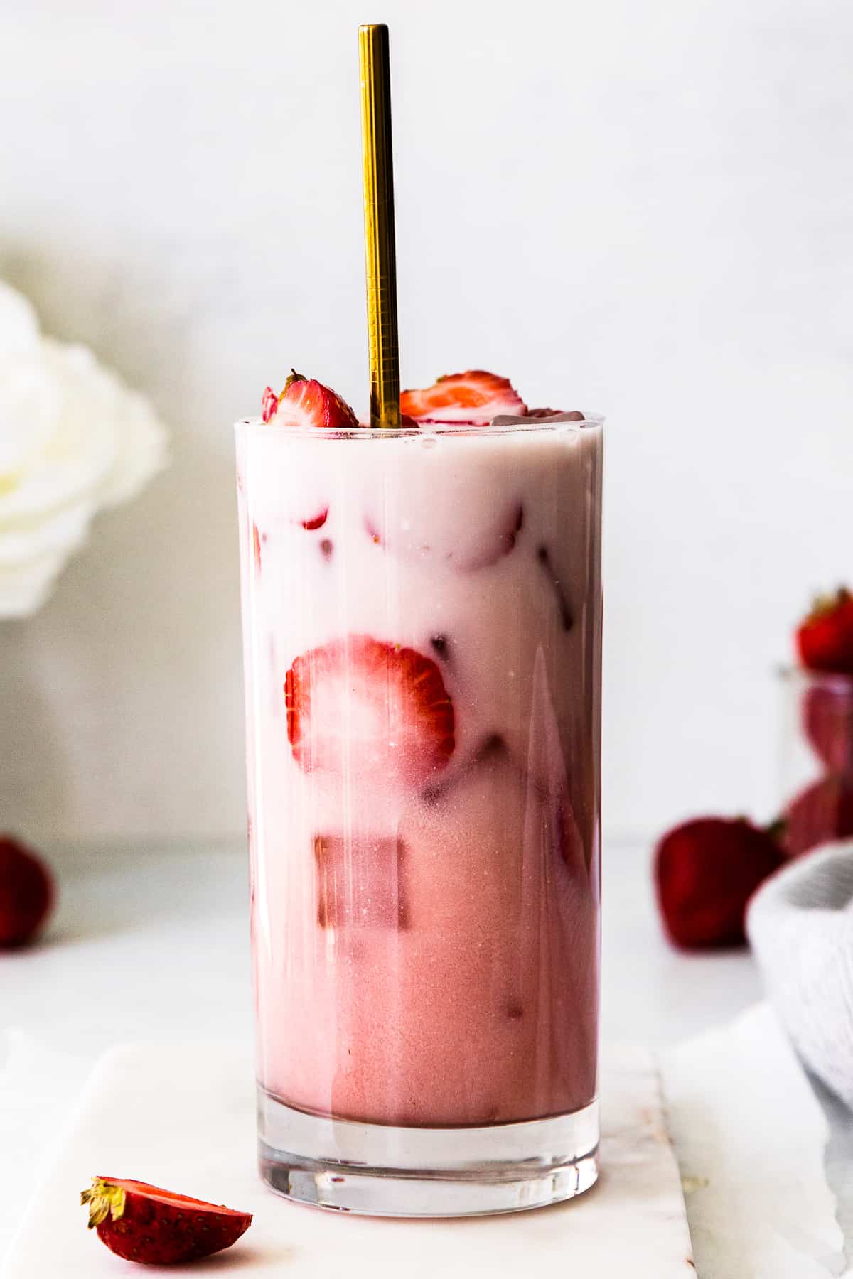 starbucks pink drink with fresh strawberries with gold straw