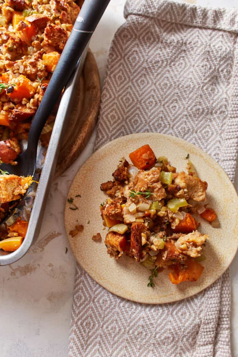 overhead view of a portion of butternut squash stuffing on a cream-colored plate.