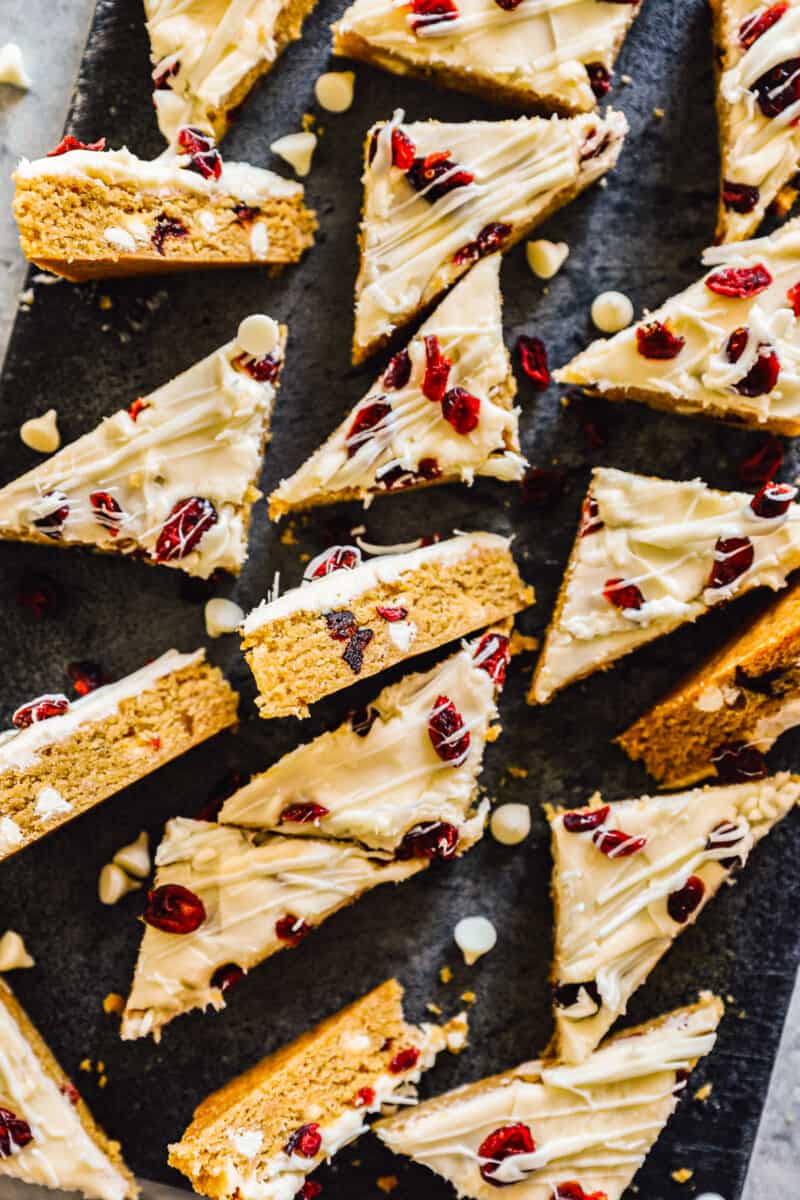 sliced cranberry bliss bars on black platter