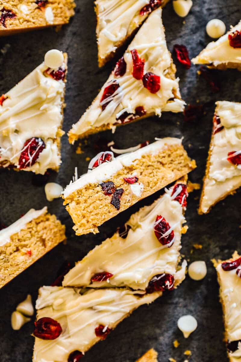 overhead sliced cranberry bliss bars on black platter