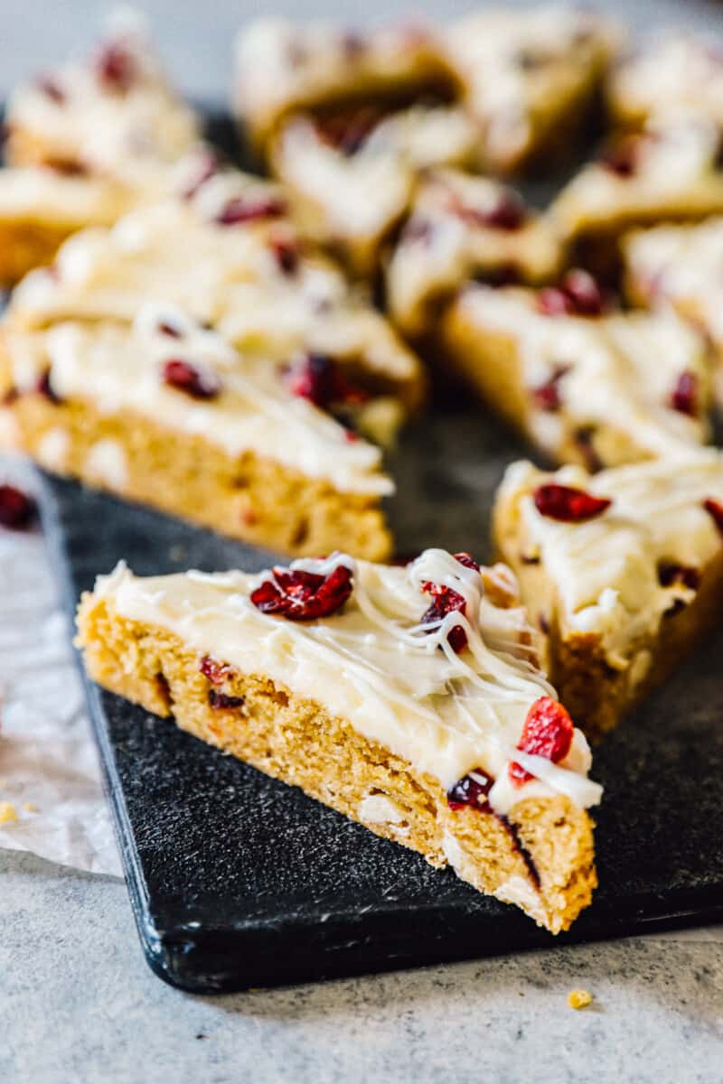 side image of cranberry bliss bars with frosting