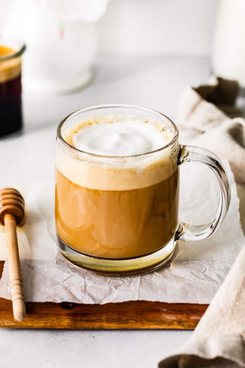 honey almond milk flat white in a clear glass mug