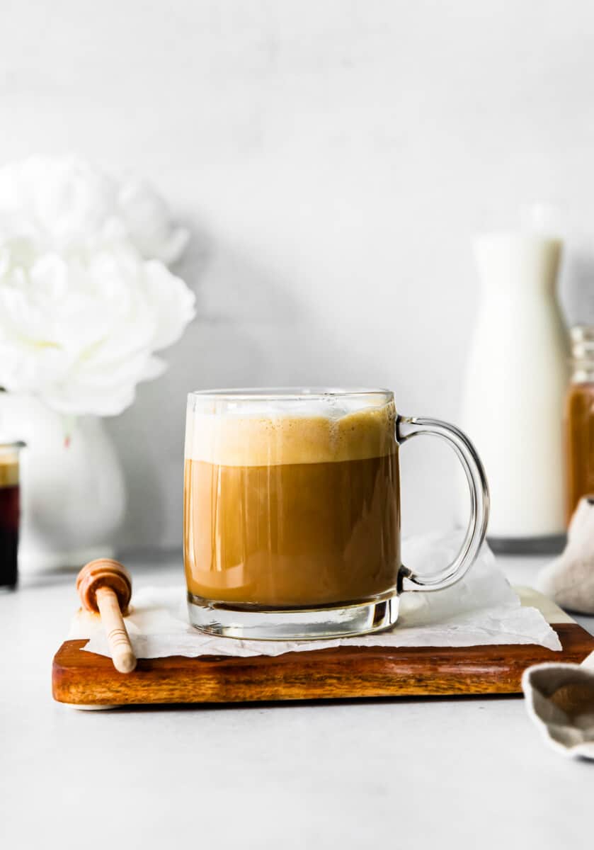 honey almond milk flat white in a clear mug