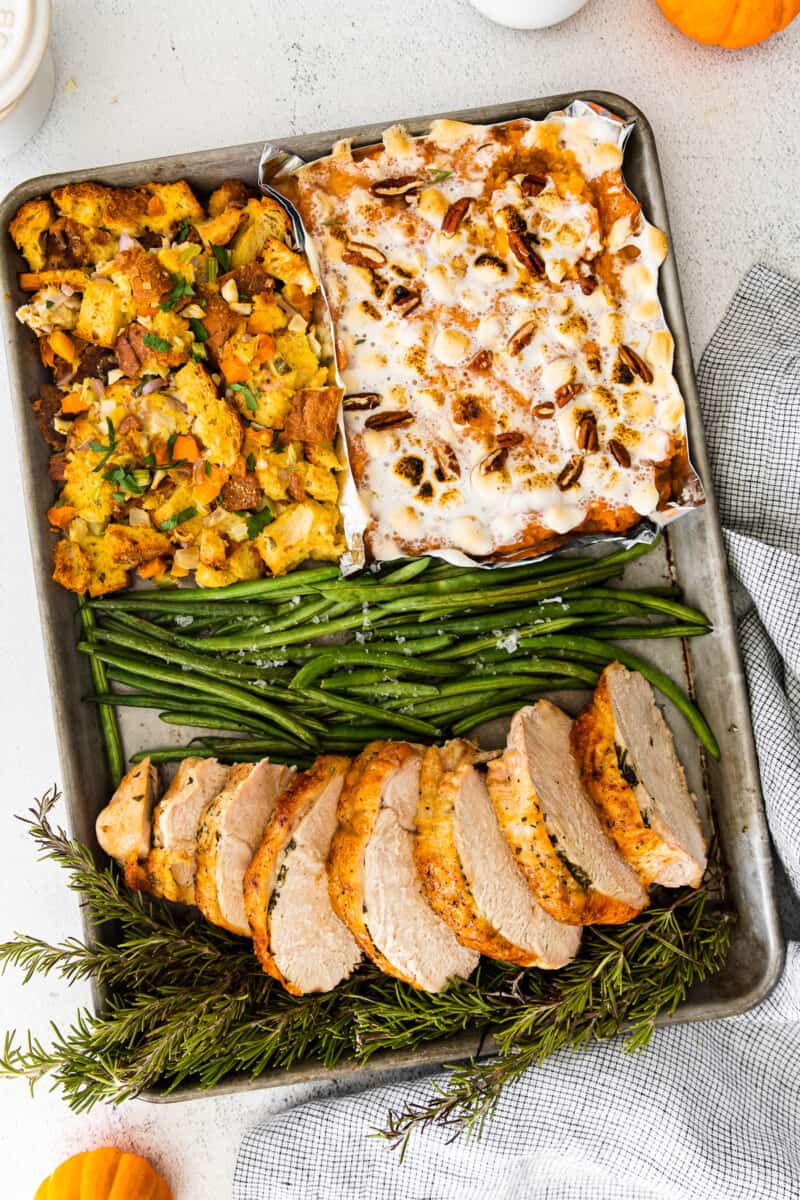 4 parts of sheet pan thanksgiving including sweet potato casserole, dressing, green beans, and turkey breast