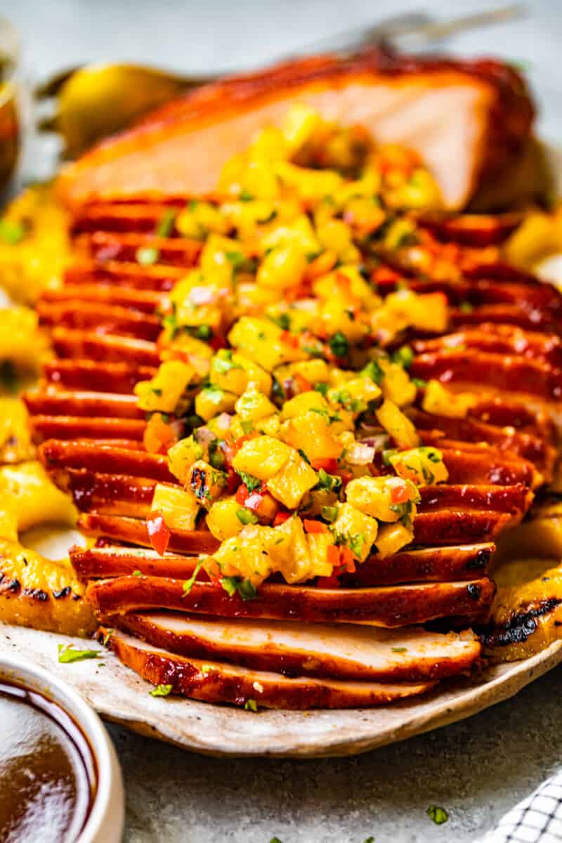 sliced huli huli turkey breast topped with pineapple salsa on a serving platter