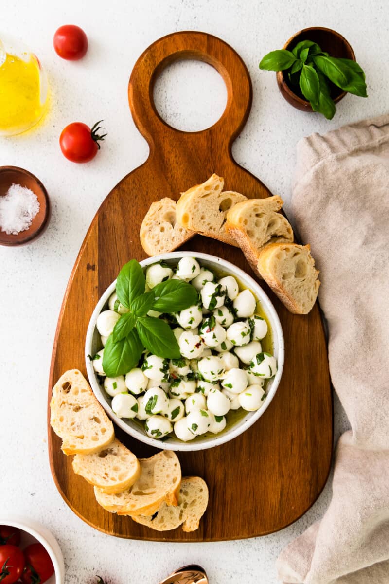 herb marinated mozzarella in white bowl