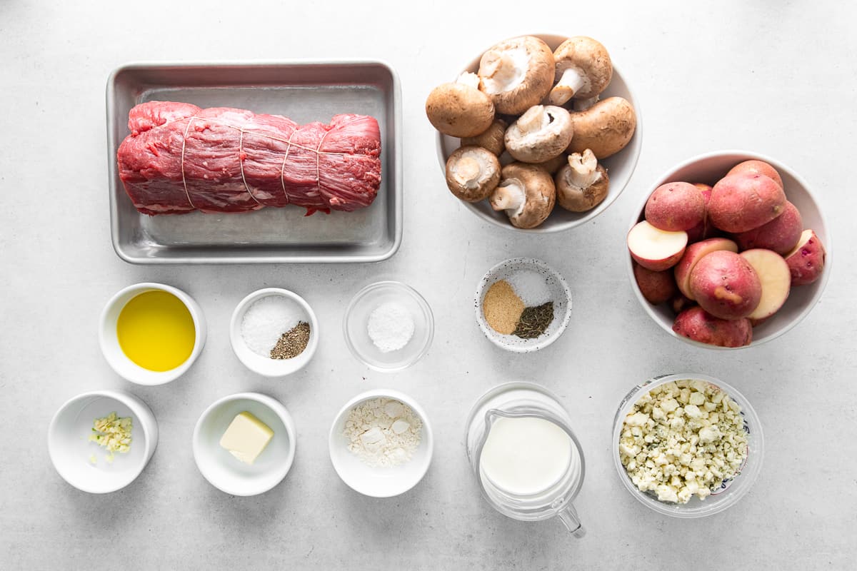 ingredients for sheet pan christmas dinner with roasted red potatoes and mushrooms with beef tenderloin