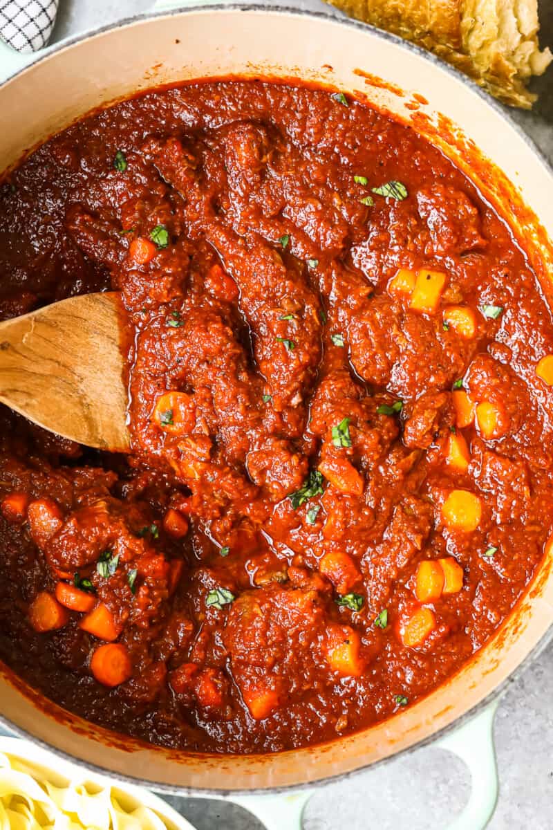 hungarian goulash in a pan with a wood spoon