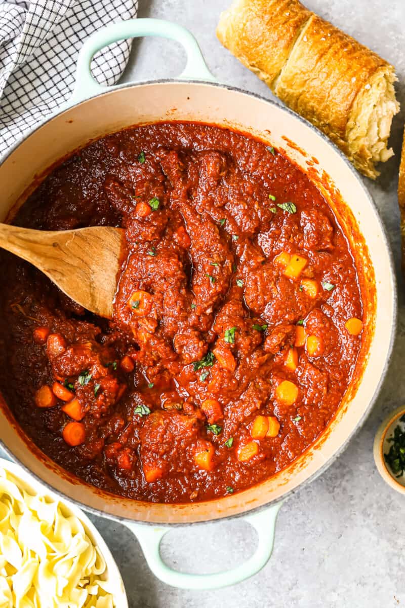 hungarian goulash in a pan with a wood spoon