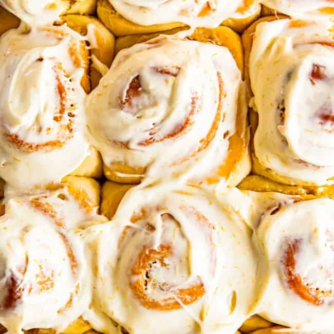 frosted orange rolls in baking dish