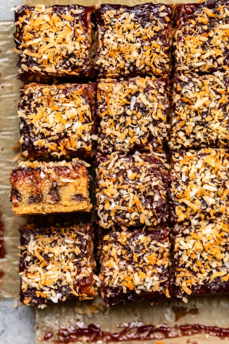 overhead image of raspberry chocolate coconut bars on parchment paper