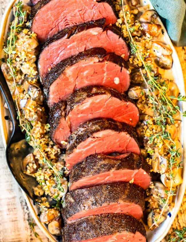 slices of beef tenderloin on a white serving platter