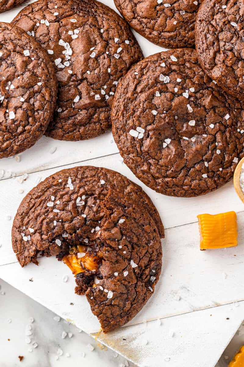 chocolate cookie broken in half showing the caramel center