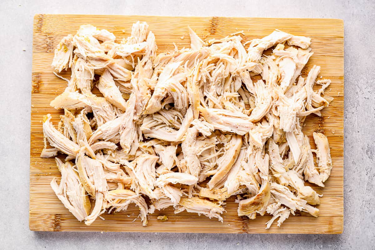 Shredded chicken on a cutting board.