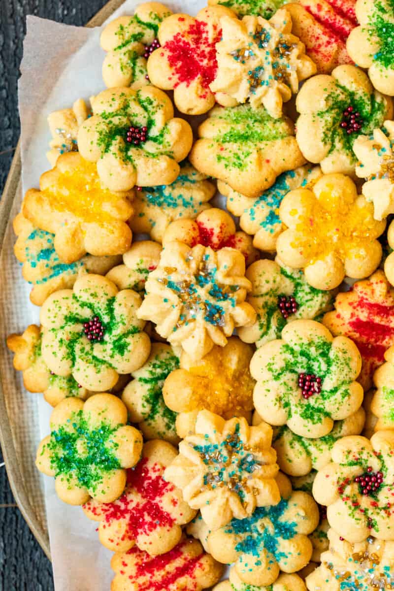 spritz cookies with sprinkles on a white serving platter