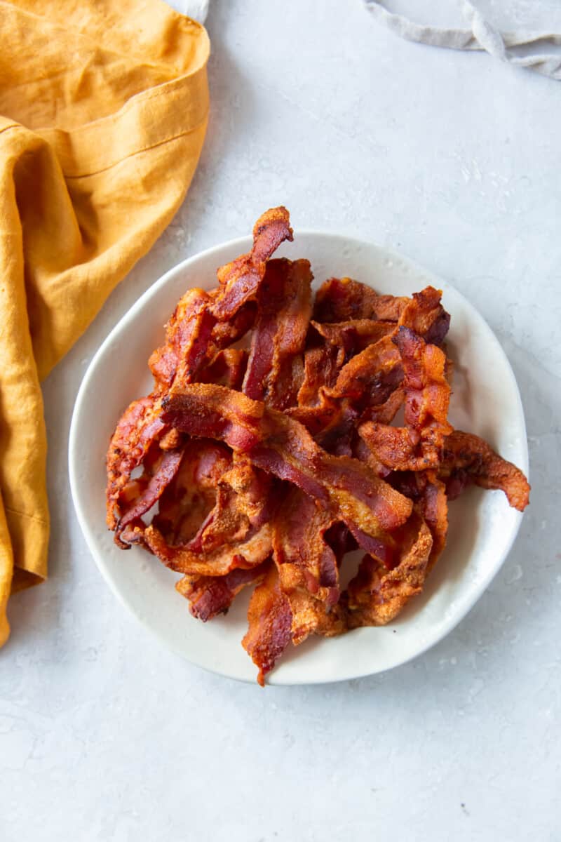 cooked bacon on a white plate