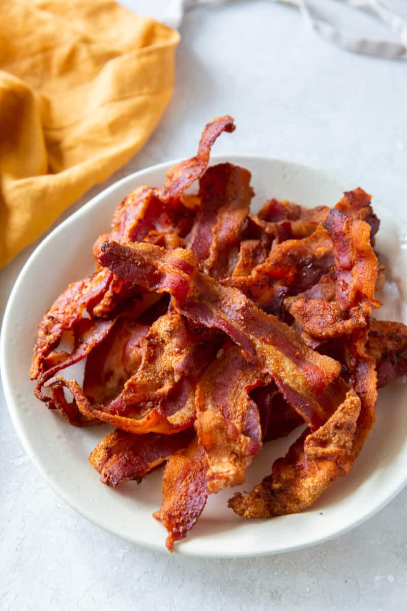 cooked bacon on a white plate