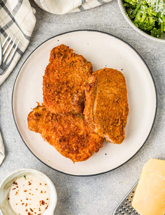 cooked pork chops on a white plate