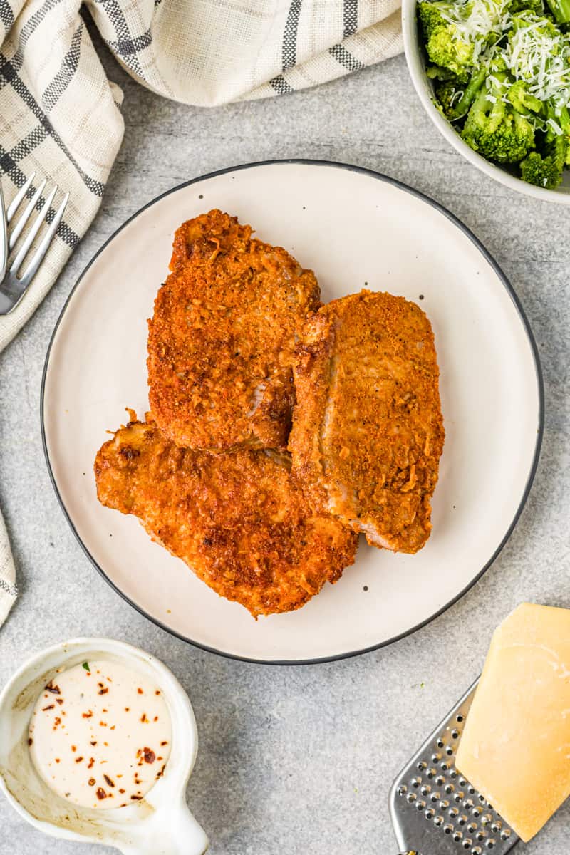 cooked pork chops on a white plate