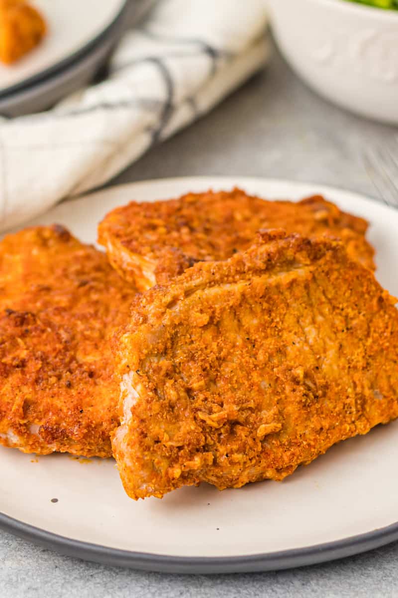 cooked pork chops on a white plate