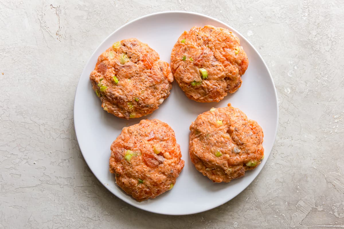 salmon burger patties on a white plate