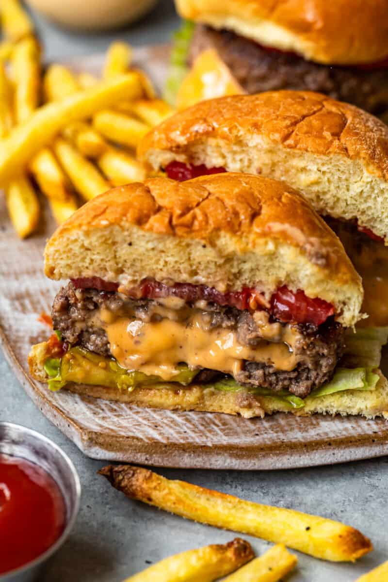 A cheese stuffed burger cut in half showing the melted cheese filling.