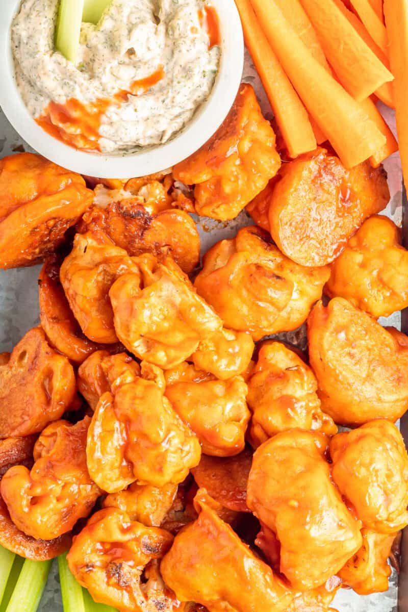 buffalo cauliflower wings on a serving tray with buffalo ranch dressing in a white bowl