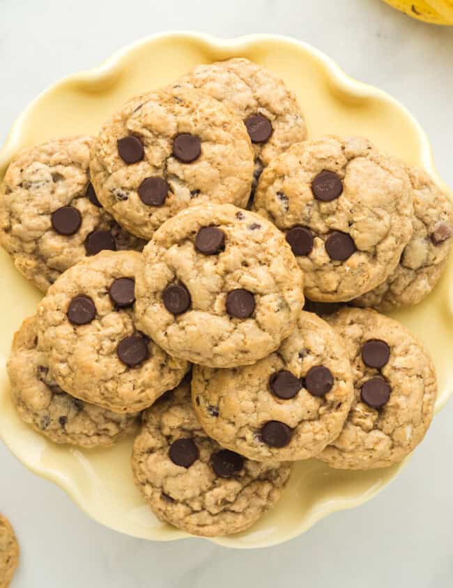 overhead image of banana breakfast cookies on a yellow plate