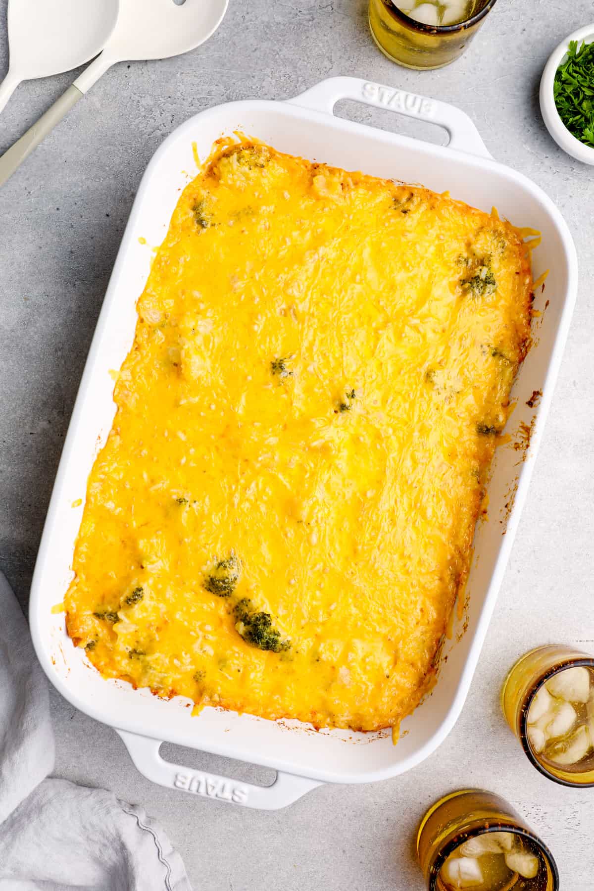 overhead image of broccoli rice casserole in a white baking dish after baking