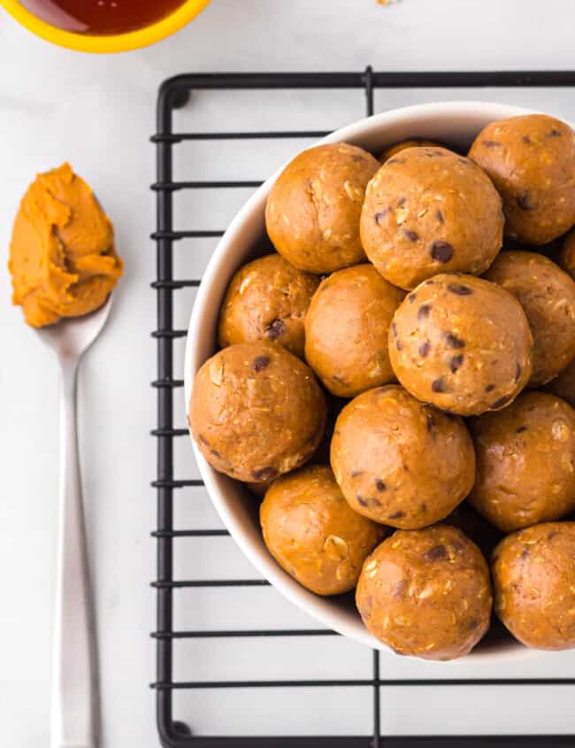 overhead image of chocolate peanut butter protein balls in a white bowl