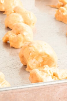 buffalo cauliflower wings on a baking sheet before baking