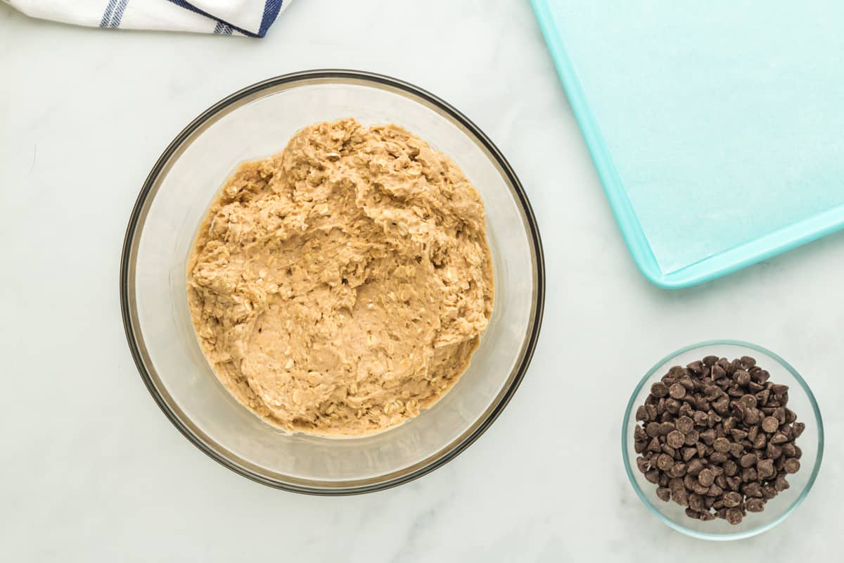 cookie dough in a glass bowl with oats.