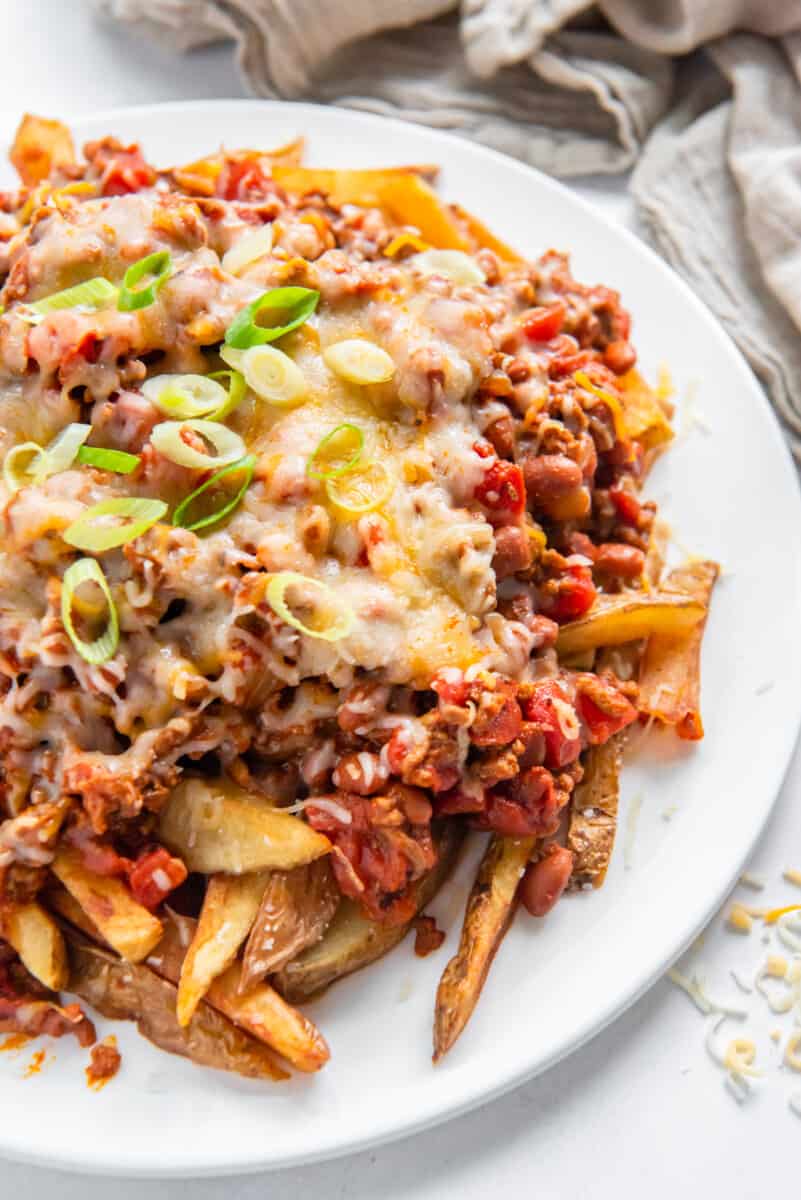 chili cheese fries on a white plate