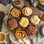 platter of bakery style cinnamon rolls, some with icing.