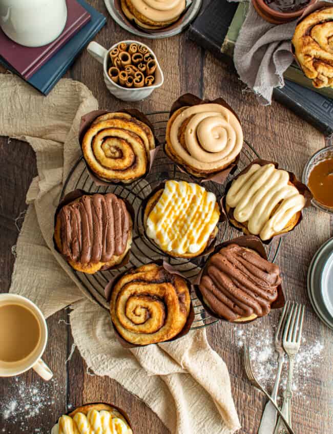 platter of bakery style cinnamon rolls, some with icing.