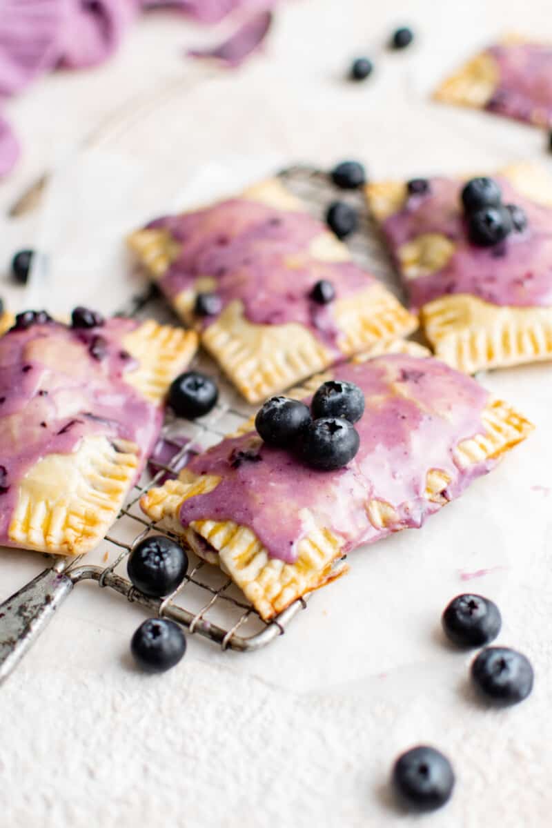 4 blueberry pop tarts on a cooling rack.