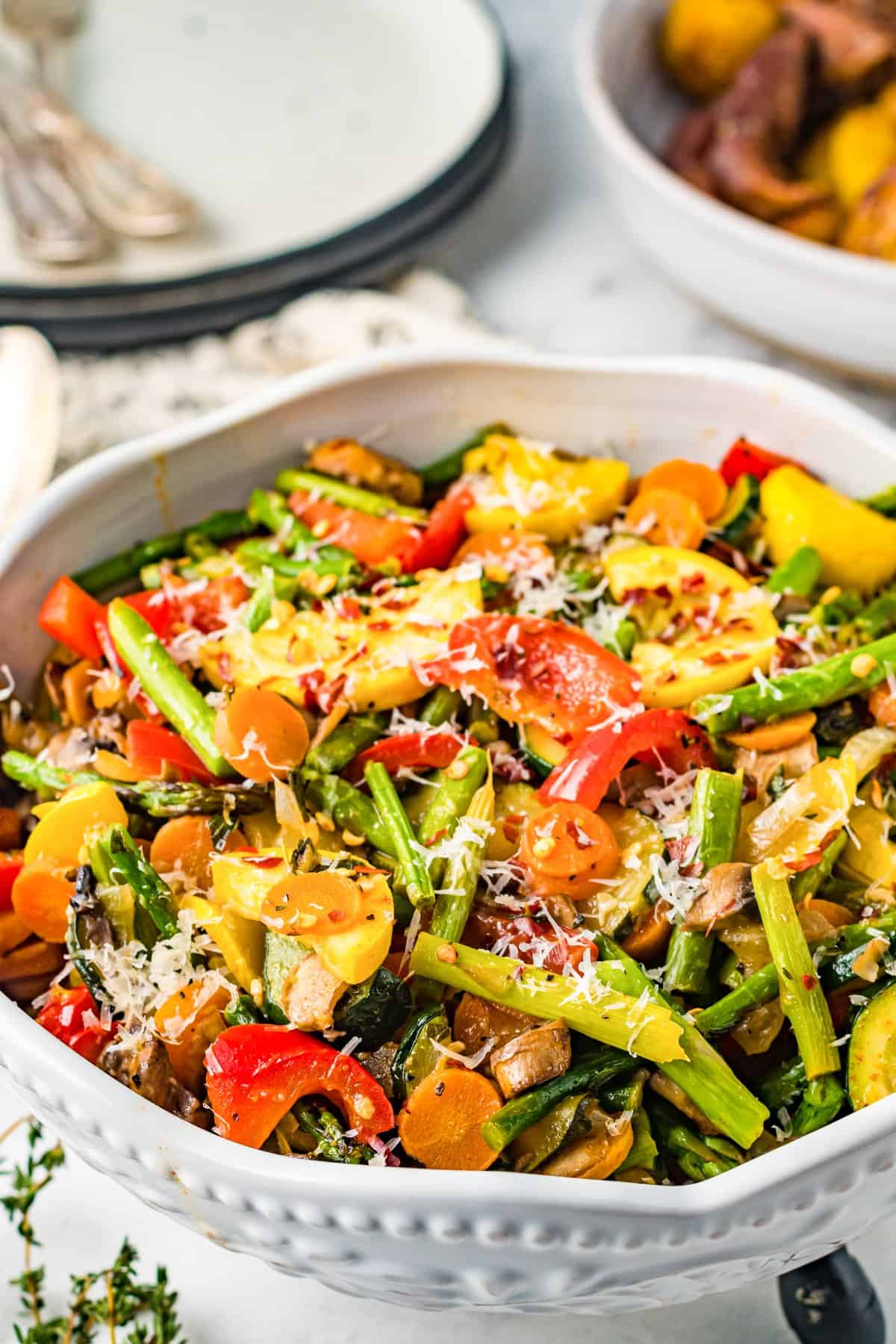 sautéed vegetables in a white serving bowl.