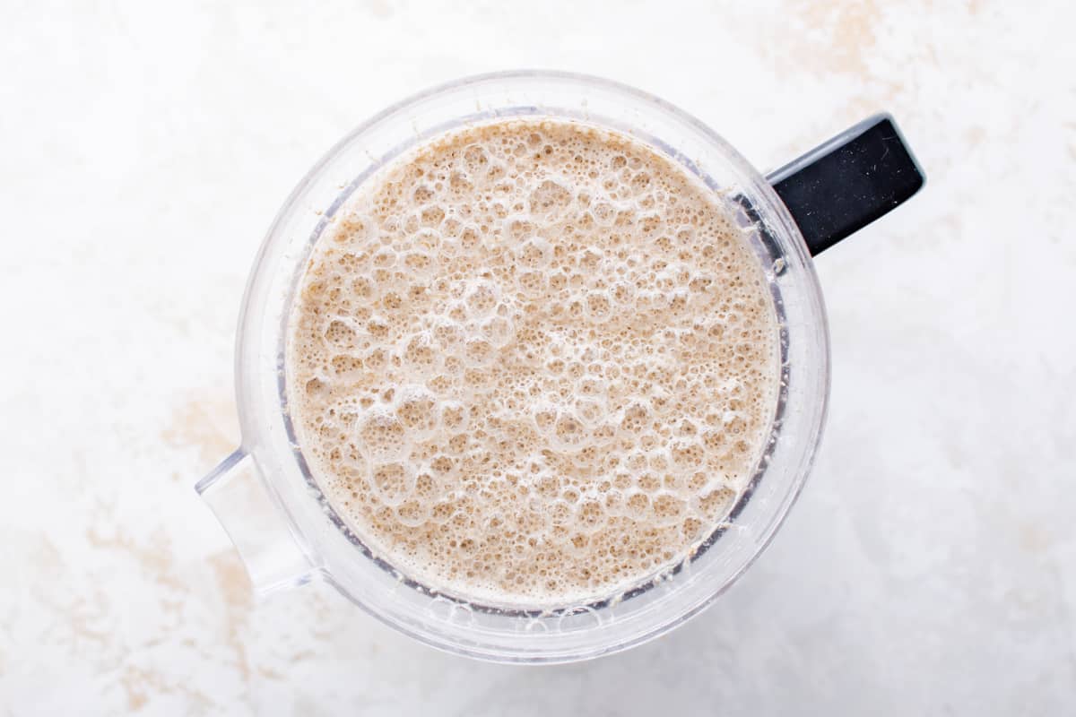 foamy blended water and oats in a blender.