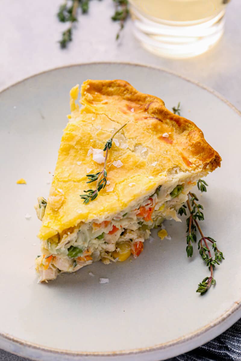 a slice of chicken pot pie on a white plate.