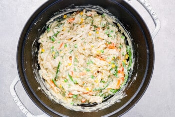 chicken pot pie filling in a white dutch oven.