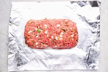 shaped instant pot meatloaf on a sheet of aluminum foil.