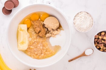 wet ingredients for reeses peanut butter cup banana bread in a white bowl.