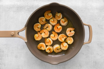 shrimp cooking in a skillet.