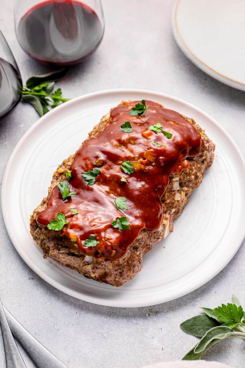 glazed instant pot meatloaf on a white serving plate.