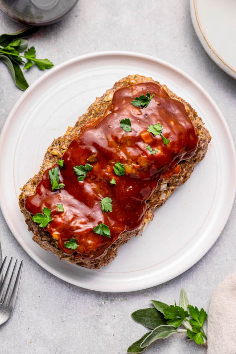 glazed instant pot meatloaf on a white serving plate.